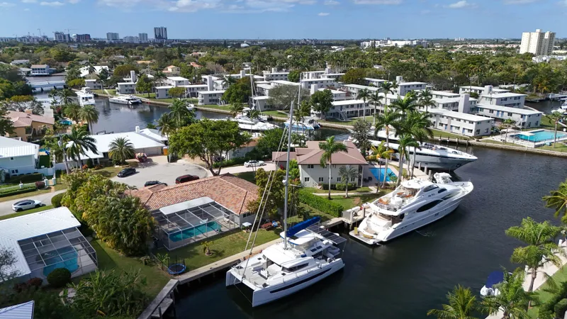 Slide: The Image of Aerial view of luxury yachts and waterfront homes in a tropical residential area. - 35