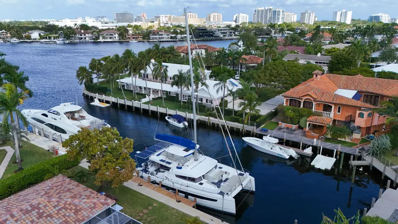 Slide: The Image of Aerial view of Bali 5.4 catamaran docked in a scenic waterfront neighborhood. - 37