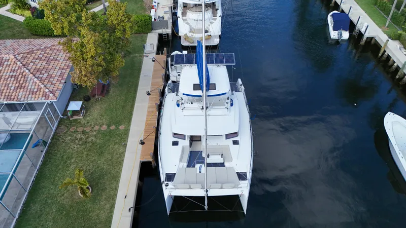 Slide: The Image of Aerial view of a 2021 Bali 5.4 catamaran docked by a canal. - 38