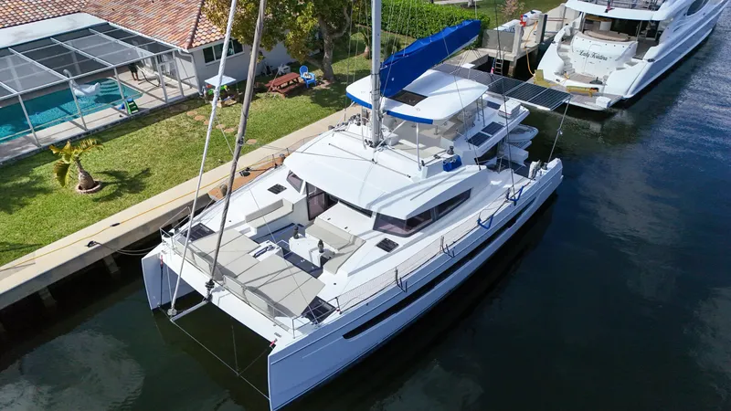 Slide: The Image of Aerial view of a 2021 Bali 5.4 catamaran docked near a house with a pool. - 39