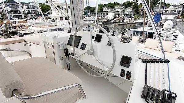 Slide: The Image of Helm of 2021 Bali 5.4 yacht with modern controls and marina view. - 7