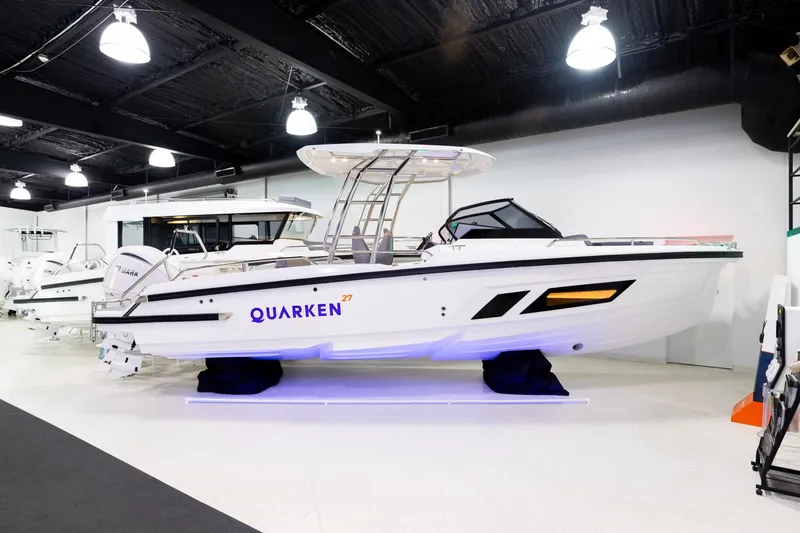 The Image of 2024 Quarken 27 T-Top V2 boat displayed in a showroom. - 1