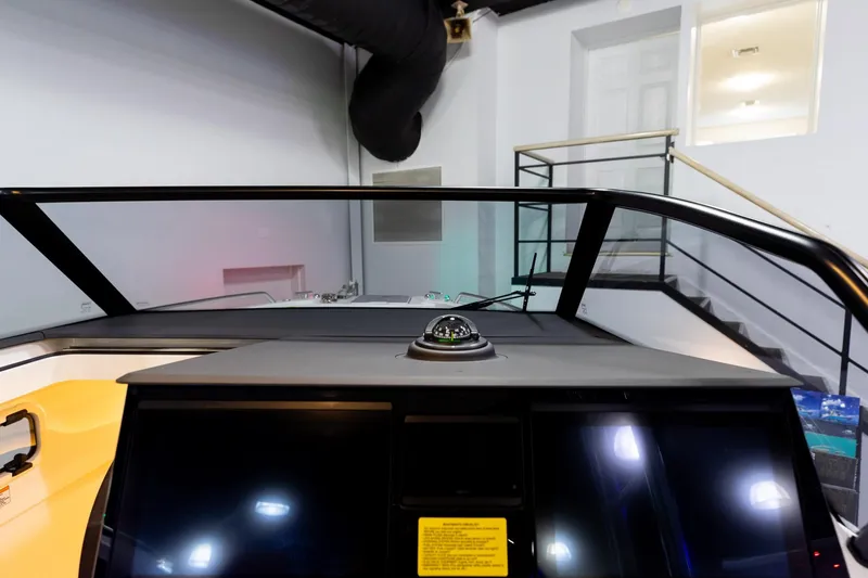 Slide: The Image of Interior view of 2024 Quarken 27 T-Top V2 boat dashboard with compass and screens. - 18