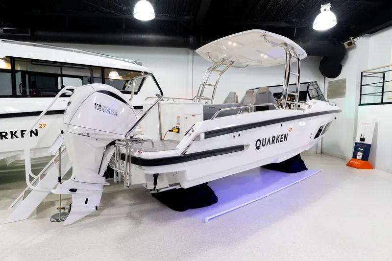 Slide: The Image of 2024 Quarken 27 T-Top V2 boat with Yamaha engine in showroom. - 2