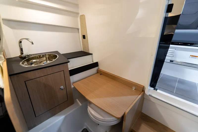 Slide: The Image of 2024 Quarken 27 T-Top V2 boat interior with compact sink and toilet area. - 22