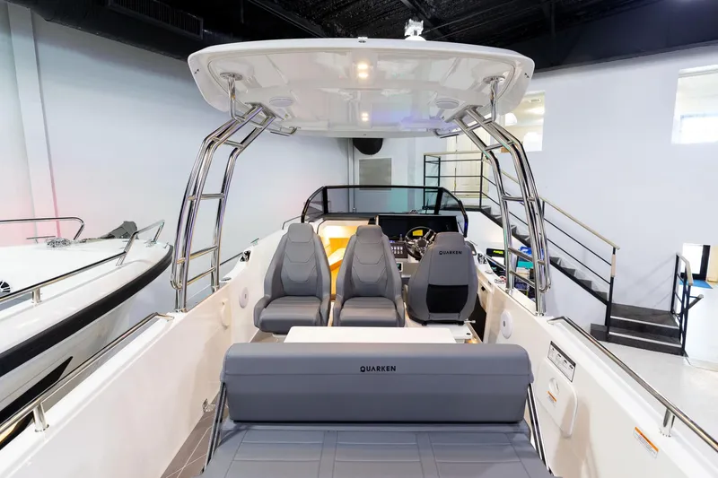 Slide: The Image of 2024 Quarken 27 T-Top V2 boat interior with seating and helm in showroom. - 4