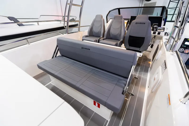 Slide: The Image of 2024 Quarken 27 T-Top V2 boat interior with gray seating and modern design. - 6