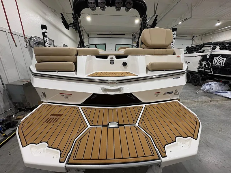 Slide: The Image of 2025 MasterCraft XT22 boat with teak deck in a showroom. - 3