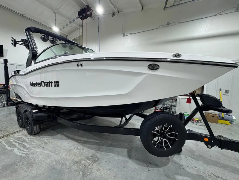 Slide: The Image of 2025 MasterCraft XT22 boat on trailer in indoor setting. - 6