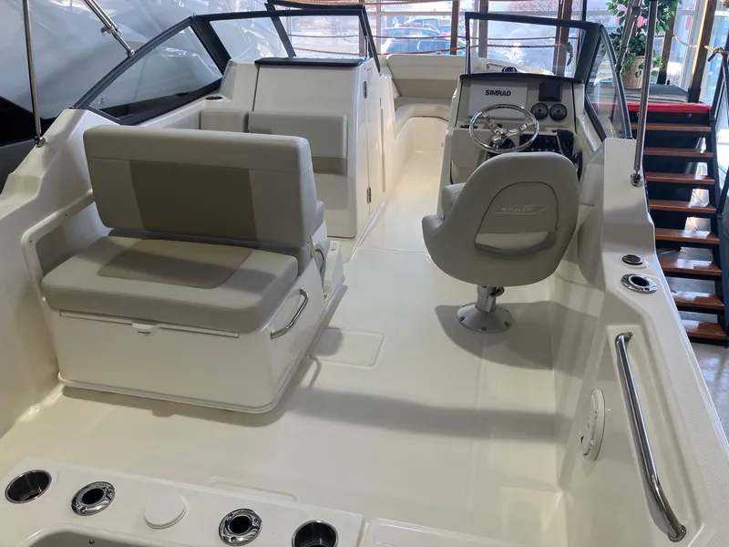 Slide: The Image of 2025 Boston Whaler 210 Vantage boat interior with seating and steering console. - 5