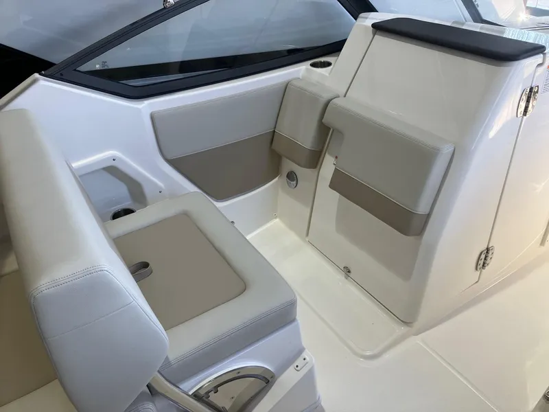 Slide: The Image of 2025 Boston Whaler 210 Vantage interior seating area with modern design and comfortable upholstery. - 7