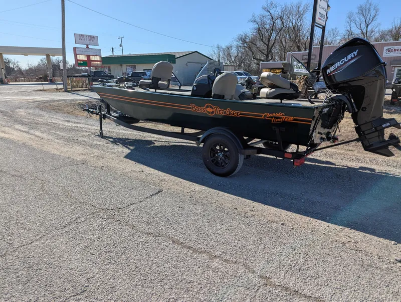 Slide: The Image of 2025 Tracker Bass Tracker Classic Limited boat on trailer, parked outdoors. - 41