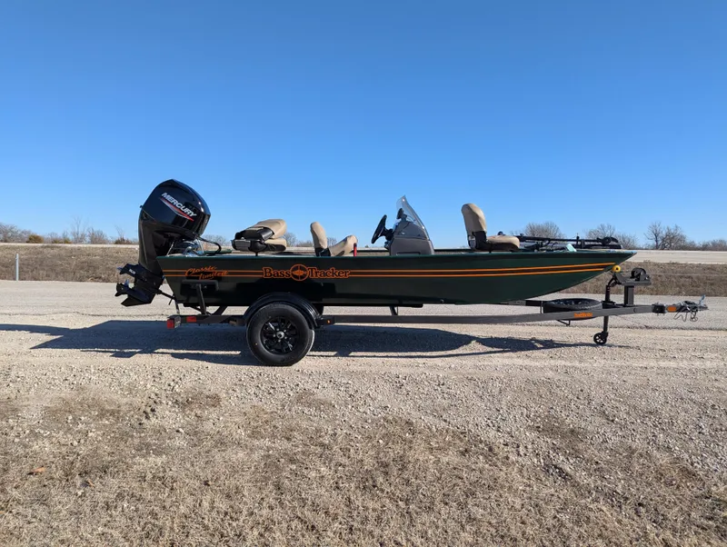 Slide: The Image of 2025 Tracker Bass Tracker Classic Limited boat on trailer, parked outdoors. - 46