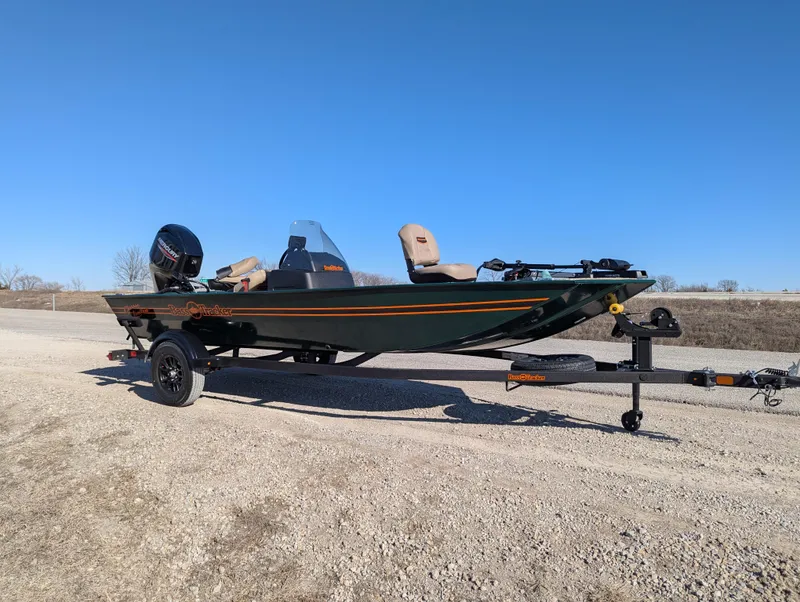 Slide: The Image of 2025 Tracker Bass Tracker Classic Limited boat on a trailer, parked on a gravel road. - 47