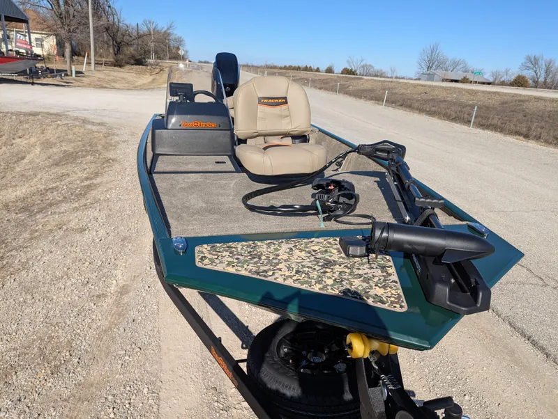Slide: The Image of 2025 Tracker Bass Tracker Classic Limited boat on a trailer, beige seats, camo accents. - 49