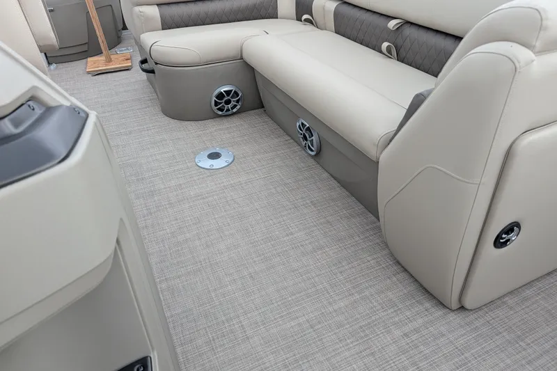 Slide: The Image of 2025 Sun Tracker SportFish 20 DLX interior with beige seating and carpeted flooring. - 104