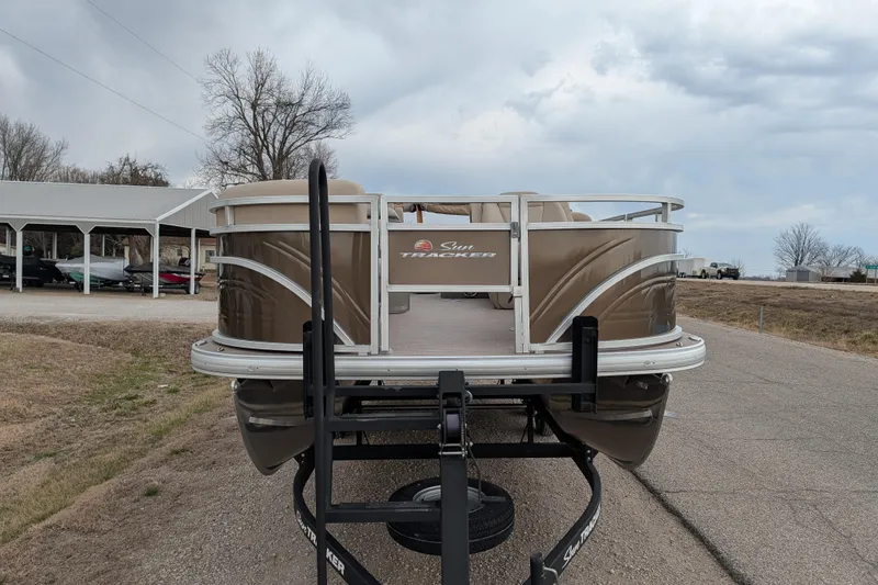 Slide: The Image of 2025 Sun Tracker SportFish 20 DLX pontoon boat on trailer, parked outdoors. - 90