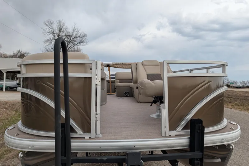 Slide: The Image of 2025 Sun Tracker SportFish 20 DLX pontoon boat with beige seating and open deck. - 91