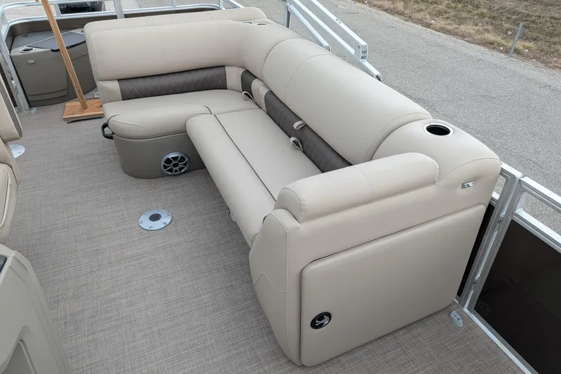 Slide: The Image of 2025 Sun Tracker SportFish 20 DLX pontoon boat interior with beige seating and cup holders. - 94