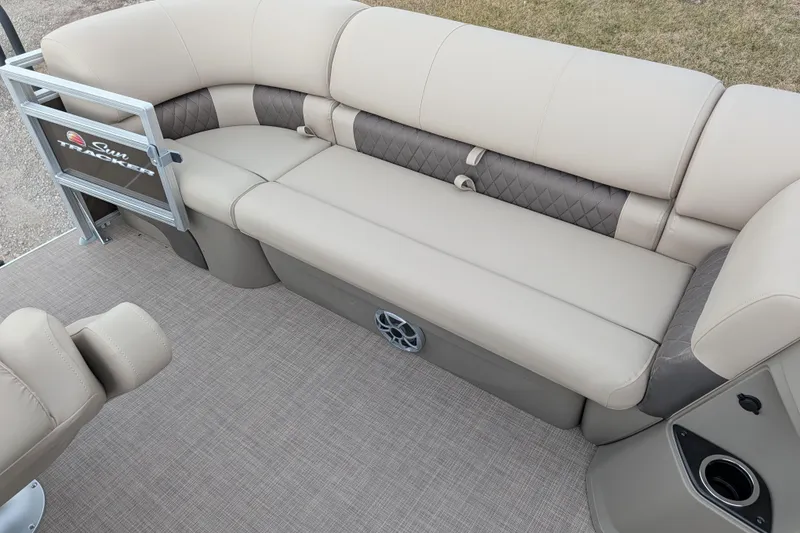 Slide: The Image of 2025 Sun Tracker SportFish 20 DLX pontoon boat interior with beige seating and carpet. - 95