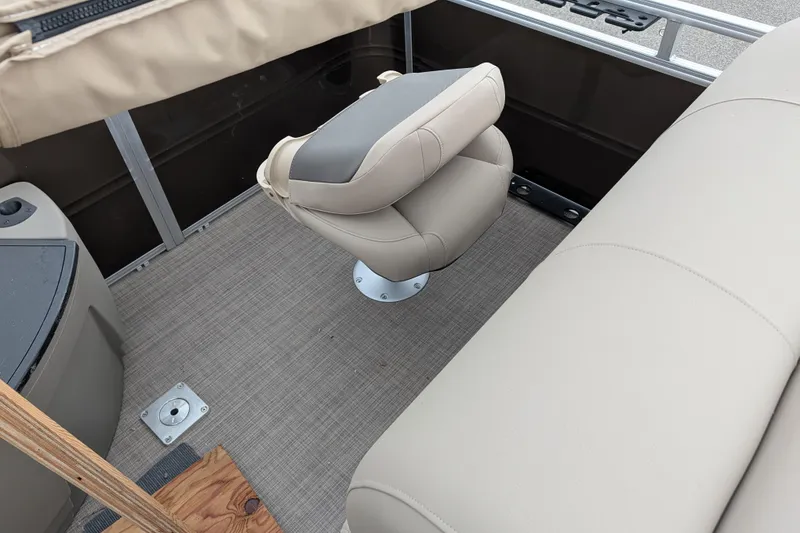 Slide: The Image of 2025 Sun Tracker SportFish 20 DLX interior with beige seating and carpeted flooring. - 97