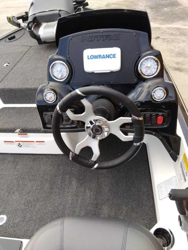 Slide: The Image of 2025 Nitro Z17 boat dashboard with steering wheel and Lowrance display. - 1