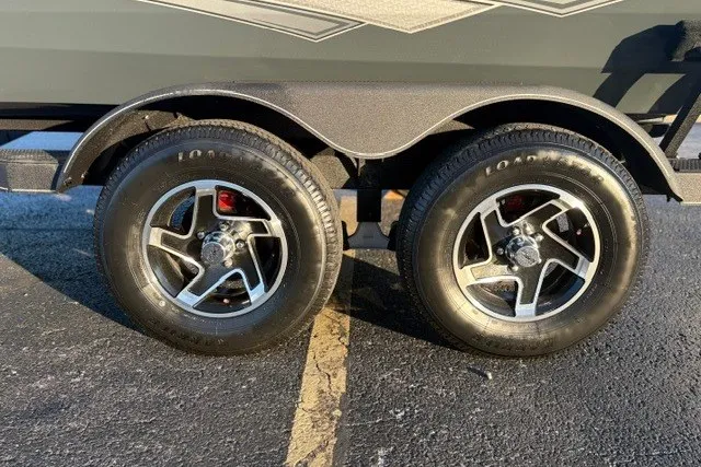 Slide: The Image of 2025 Ranger RT198P trailer wheels on asphalt, showcasing dual tires and sleek rims. - 13