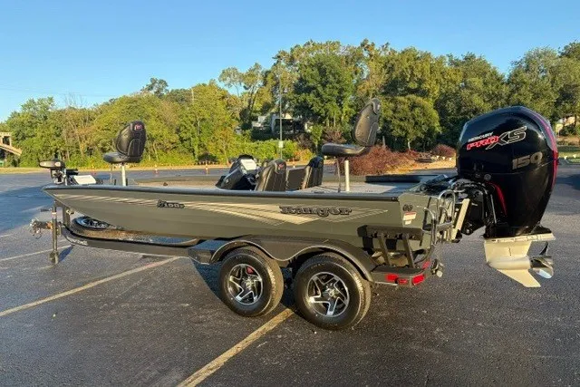 Slide: The Image of 2025 Ranger RT198P boat with dual seats and powerful outboard motor in a parking lot. - 4