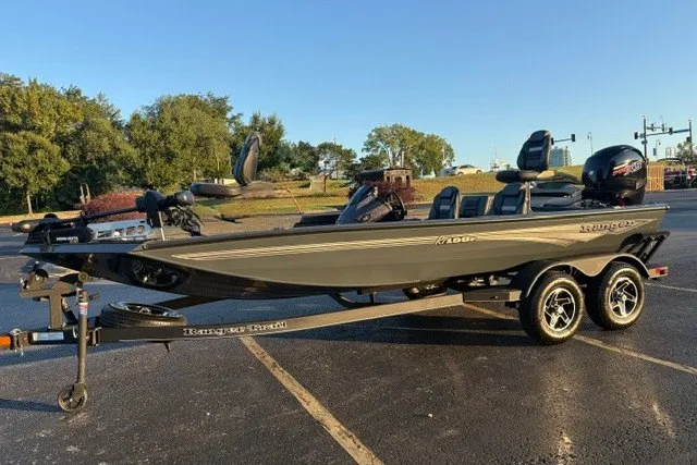 Slide: The Image of 2025 Ranger RT198P fishing boat on trailer, parked outdoors in sunny setting. - 9