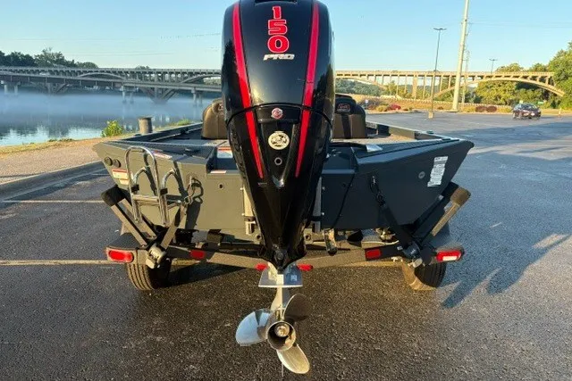 Slide: The Image of 2025 Ranger RT198P boat with 150 HP engine, parked near a scenic river. - 6