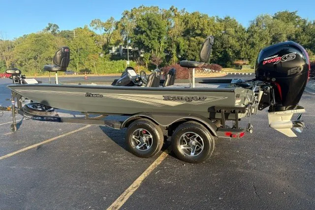 Slide: The Image of 2025 Ranger RT198P fishing boat with trailer, parked outdoors on sunny day. - 11