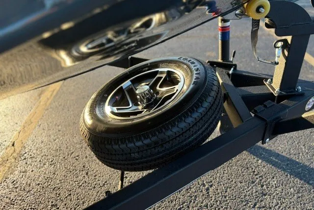 Slide: The Image of 2025 Ranger RT198P trailer with spare tire on a sunny day. - 32