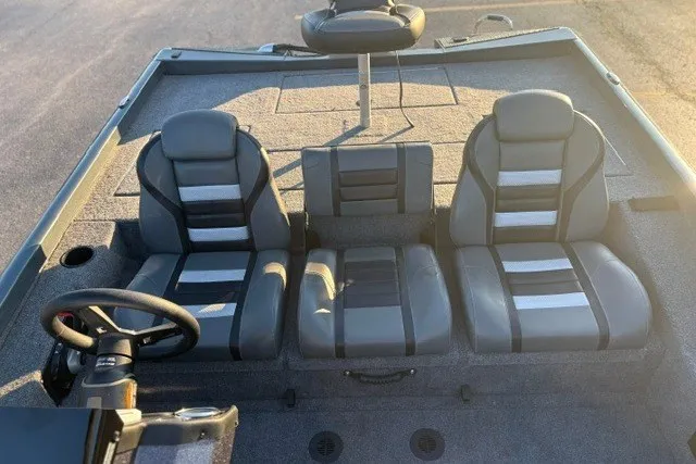 Slide: The Image of 2025 Ranger RT198P boat interior with three gray seats and steering wheel. - 17