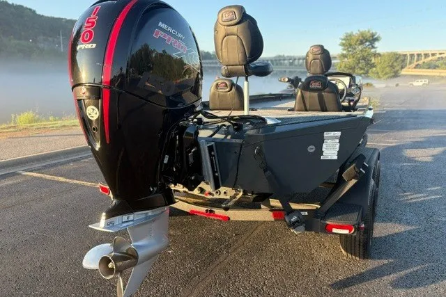 Slide: The Image of 2025 Ranger RT198P boat with Mercury 150 Pro XS engine, parked near a scenic lake. - 7