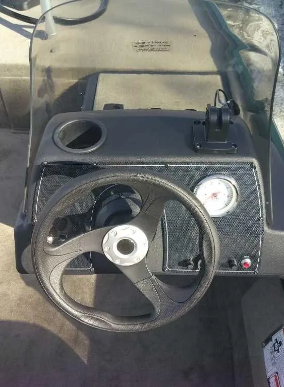 Slide: The Image of 2025 Tracker Bass Tracker Classic Limited dashboard with steering wheel and gauge. - 2