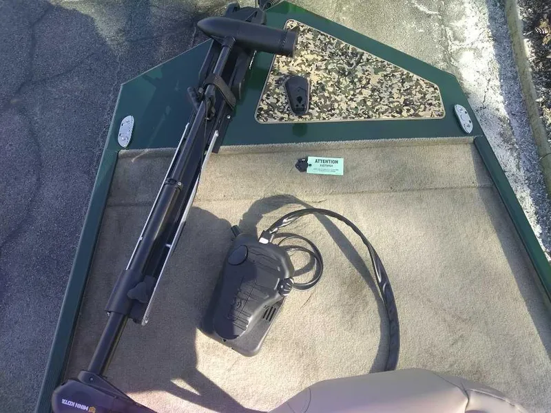 Slide: The Image of 2025 Tracker Bass Tracker Classic Limited boat deck with trolling motor and foot pedal. - 3