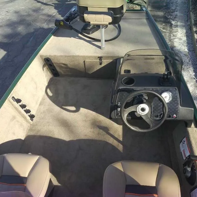 Slide: The Image of 2025 Tracker Bass Tracker Classic Limited boat interior with steering console and seating. - 4