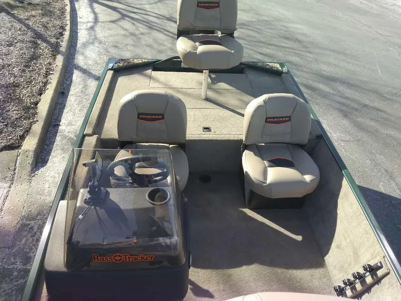 Slide: The Image of 2025 Tracker Bass Tracker Classic Limited boat interior with seating and steering console. - 5