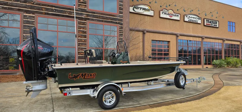 Slide: The Image of 2025 Mako 18 Pro Skiff Backwater Edition boat displayed outside dealership. - 2