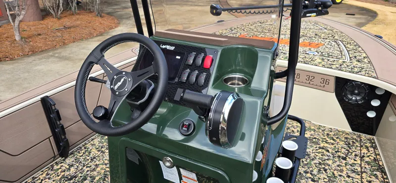 Slide: The Image of 2025 Mako 18 Pro Skiff Backwater Edition console with steering wheel and controls. - 4