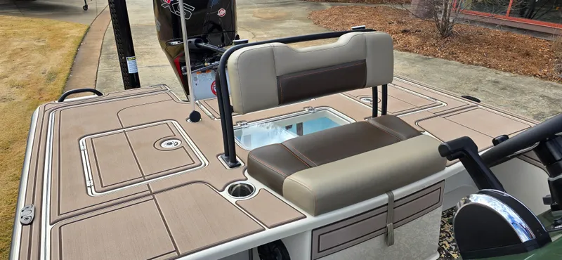 Slide: The Image of 2025 Mako 18 Pro Skiff Backwater Edition boat interior with seating and storage compartments. - 6