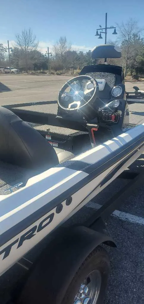 Slide: The Image of 2025 Nitro Z17 boat with sleek design, parked outdoors on a sunny day. - 2