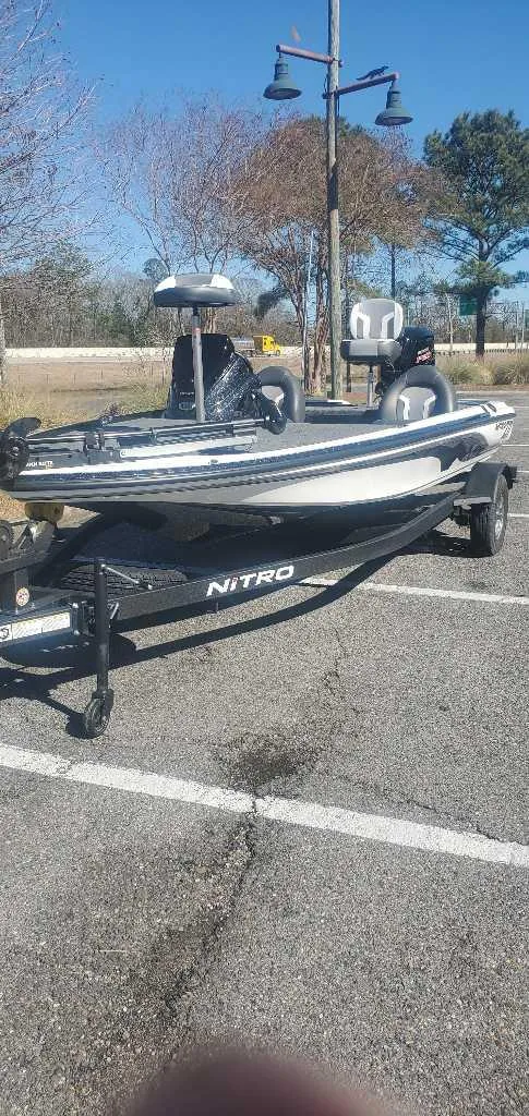 Slide: The Image of 2025 Nitro Z17 boat on trailer in parking lot, sunny day. - 5