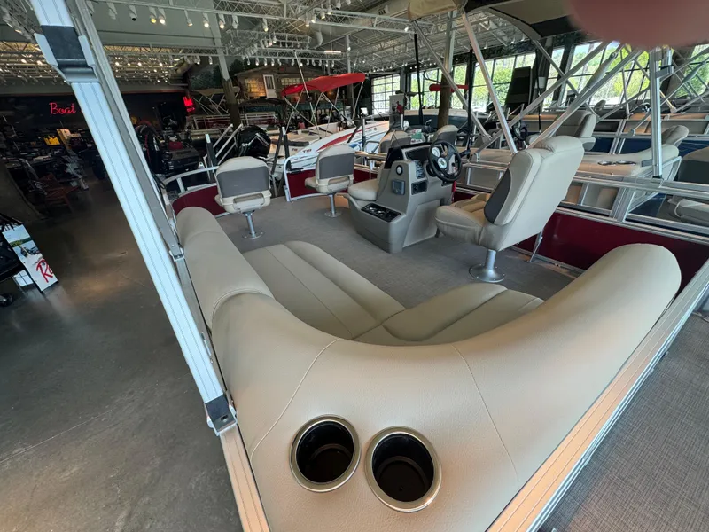 Slide: The Image of 2025 Sun Tracker Bass Buggy 16 XL Select interior with seating and steering console. - 2