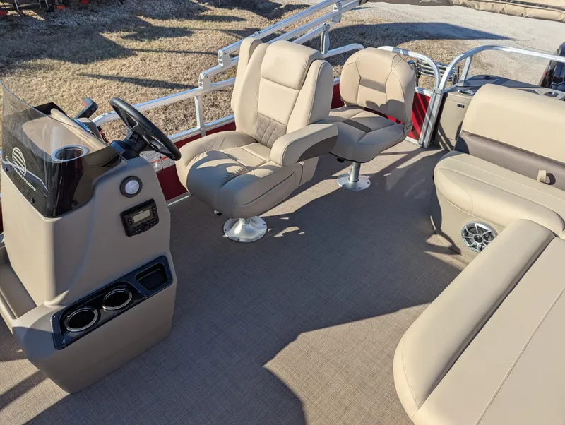 Slide: The Image of 2025 Sun Tracker Bass Buggy 18 DLX interior with beige seating and steering console. - 10