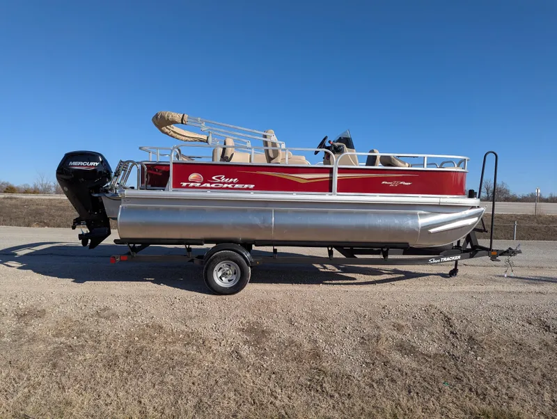 Slide: The Image of 2025 Sun Tracker Bass Buggy 18 DLX pontoon boat on trailer, side view. - 6