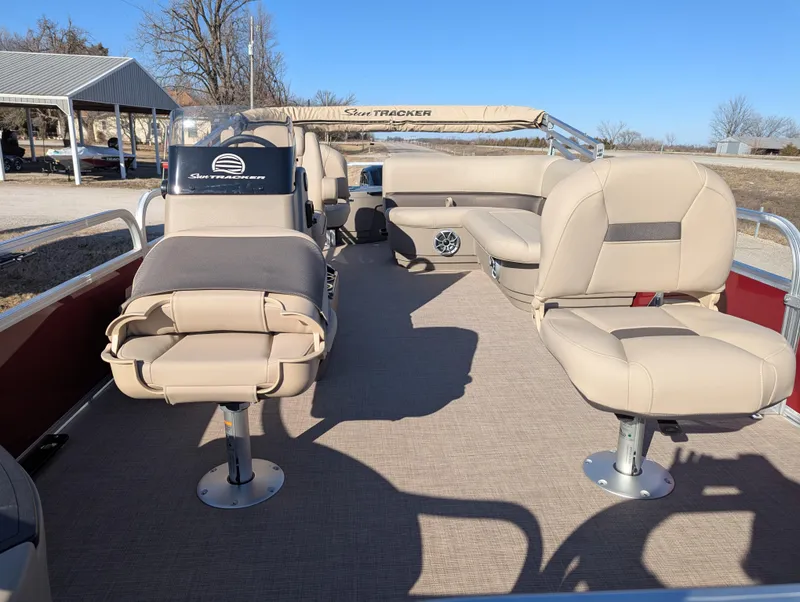 Slide: The Image of 2025 Sun Tracker Bass Buggy 18 DLX pontoon boat interior with beige seating. - 9