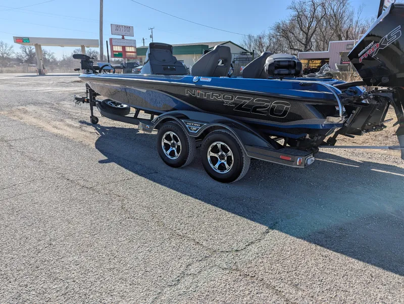 Slide: The Image of 2025 Nitro Z20 XL Pro boat on trailer, parked outdoors in a sunny setting. - 2