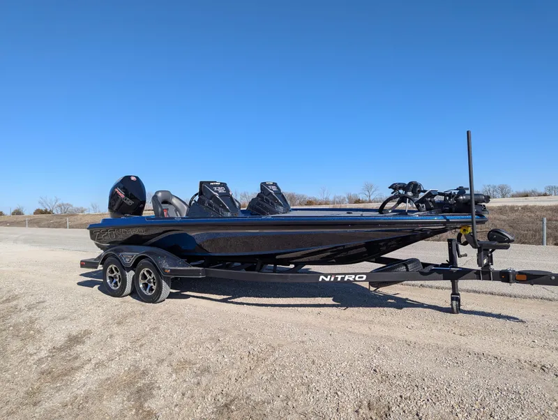 Slide: The Image of 2025 Nitro Z20 XL Pro boat on trailer, parked on gravel under clear blue sky. - 8