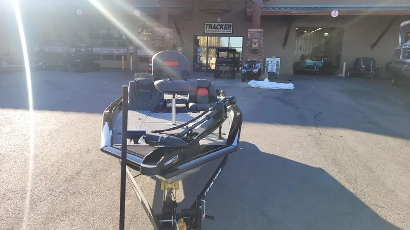 Slide: The Image of 2025 Tracker Pro Team 190 boat parked outside dealership. - 3